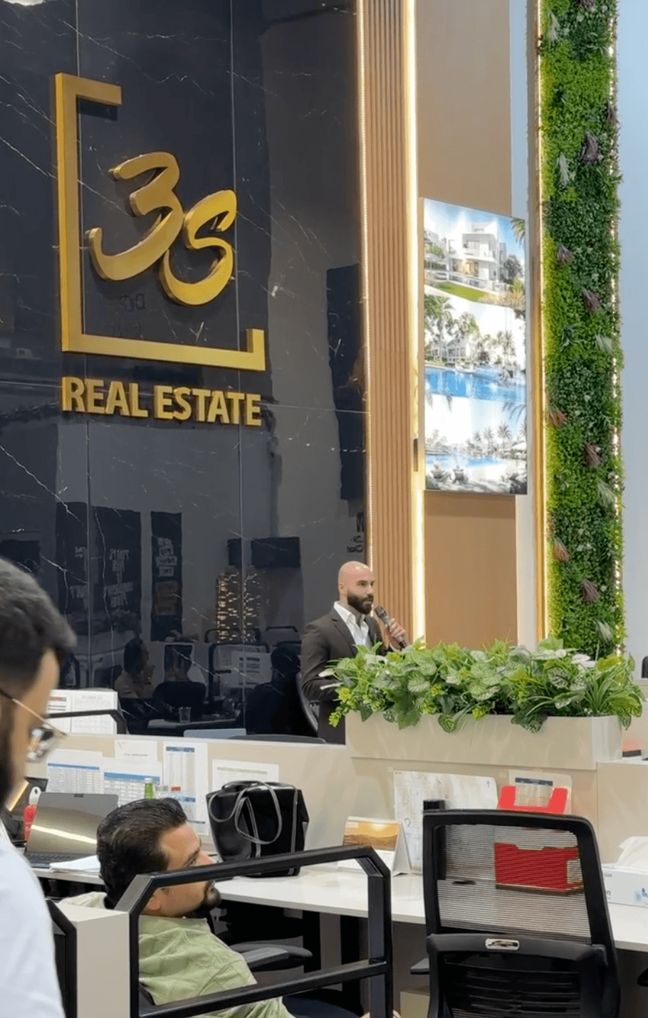 Navid Rashid presenting to a sales floor at 3S Real Estate