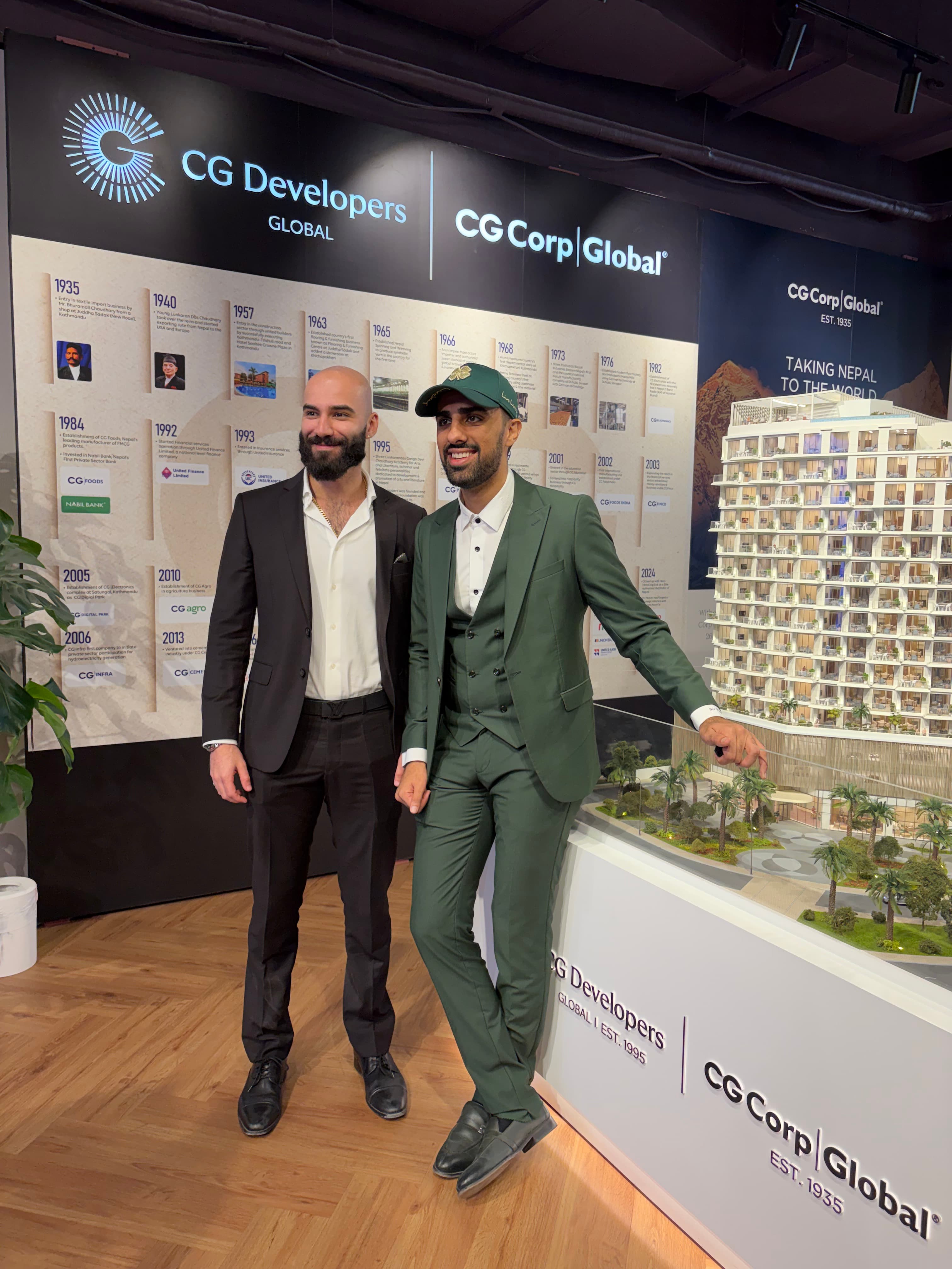 Navid Rashid at the CG Developers Global showroom beside a project model