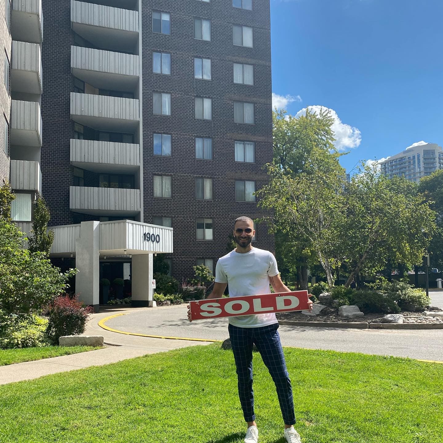 Sold closing in front of a residential building at 1900