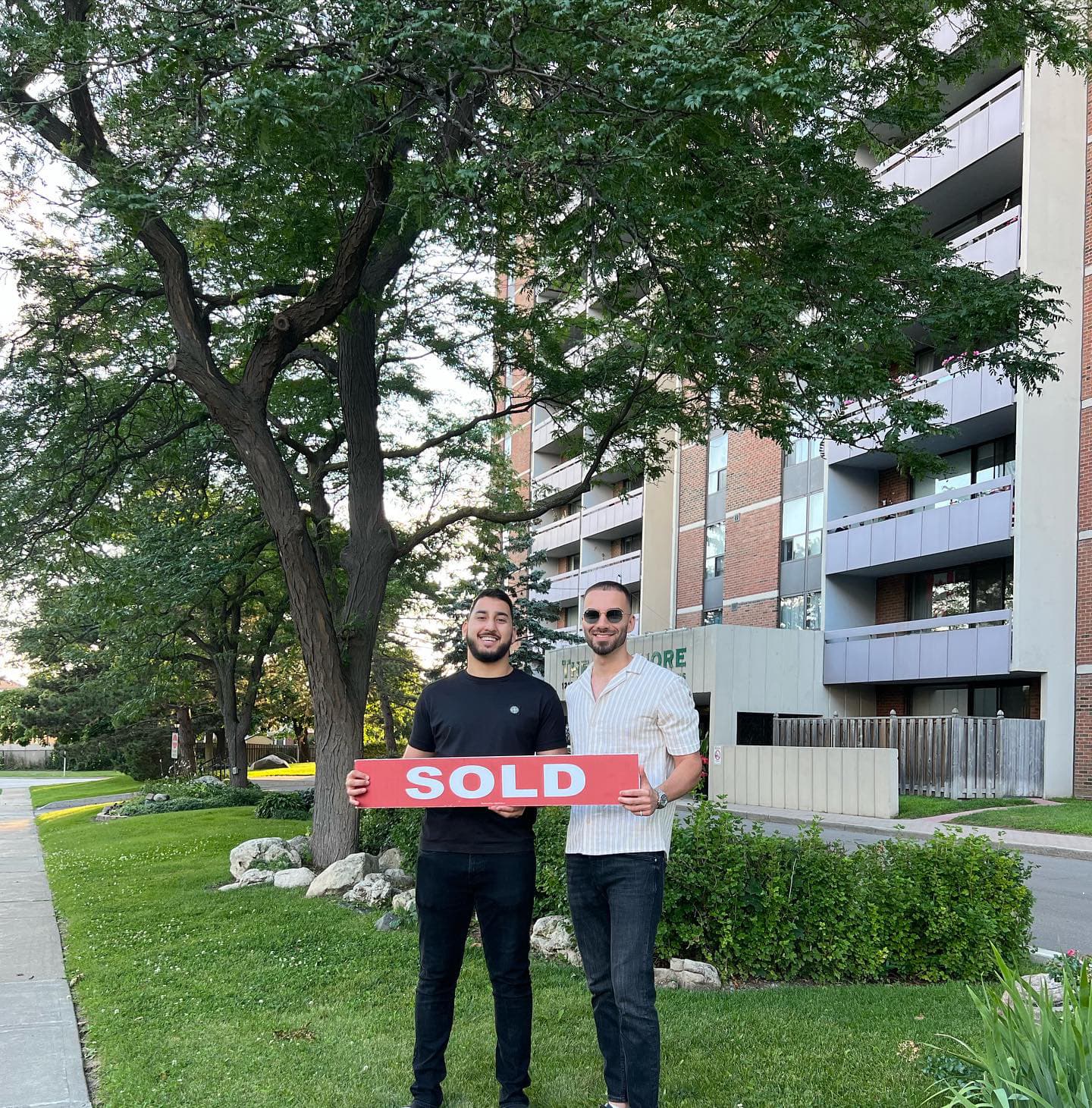 Sold closing with a partner outside a mid-rise building